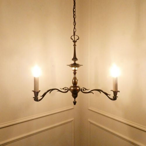 fig 1. An early 20th-century Dutch bronze two-light chandelier featuring a baluster-turned central stem and curved scrolling arms.