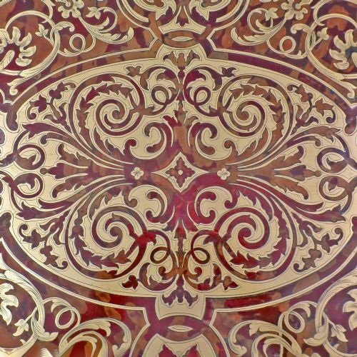 fig 2. A French Louis XV style Boulle games table featuring brass and tortoiseshell marquetry, gilded ormolu mounts, and cabriole legs.