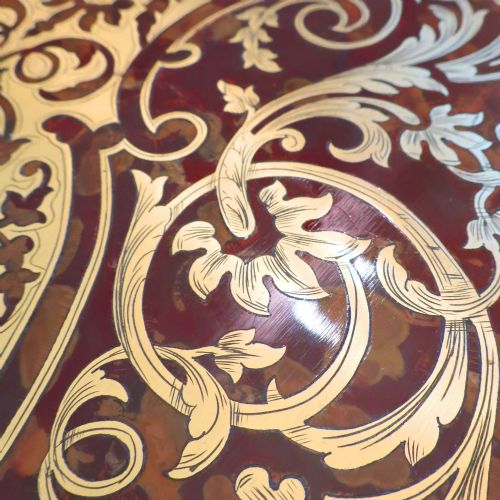 fig 4. A French Louis XV style Boulle games table featuring brass and tortoiseshell marquetry, gilded ormolu mounts, and cabriole legs.