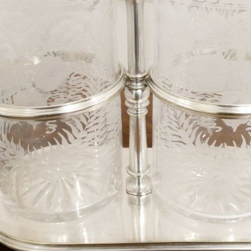 fig 2. A Victorian silver-plated decanter stand with a central arched handle holding three etched glass decanters with stoppers.