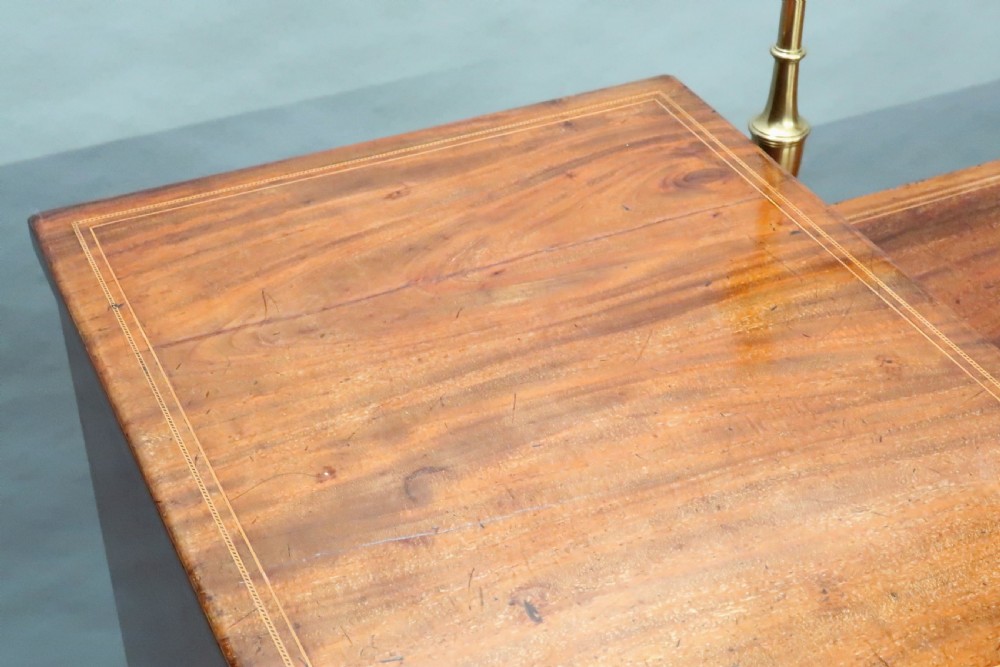 A Georgian mahogany pedestal sideboard featuring twin end pedestals with oval inlaid cupboards, a central frieze drawer, and a brass gallery along the back rail. View II