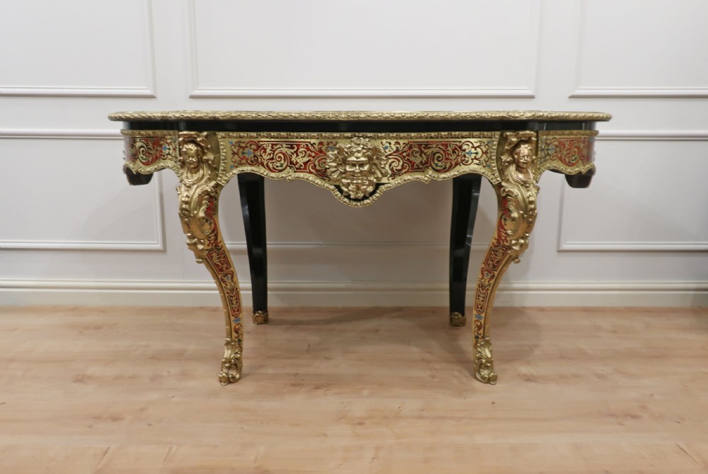 A French Louis XV style Boulle bureau plat writing desk featuring brass marquetry inlay, red leather surface, gilt bronze mounts, and cabriole legs. View VI