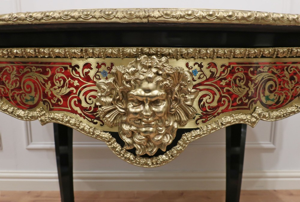 A French Louis XV style Boulle bureau plat writing desk featuring brass marquetry inlay, red leather surface, gilt bronze mounts, and cabriole legs. View VII
