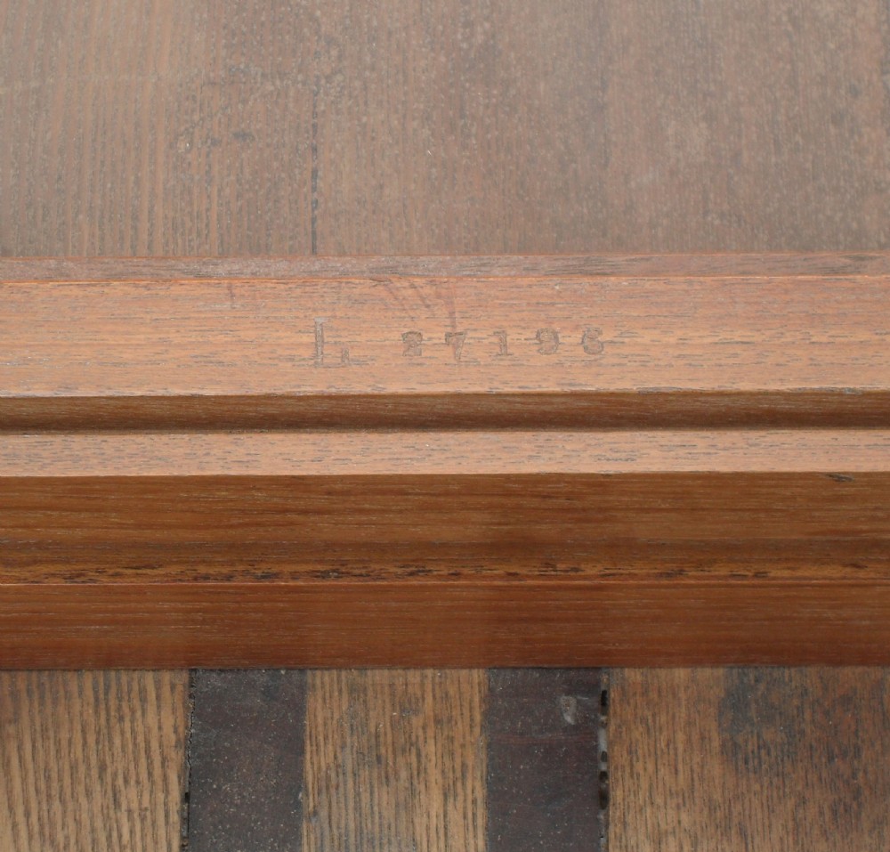 A long Victorian mahogany imperial extending dining table with a polished surface finish, fluted turned legs, and brass castors. View VII