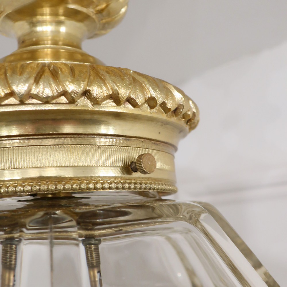 A French Louis XVI style ceiling lantern featuring gilt bronze mounts, a carved acanthus leaf canopy, faceted cut glass body, and a knopped drop finial. View VII