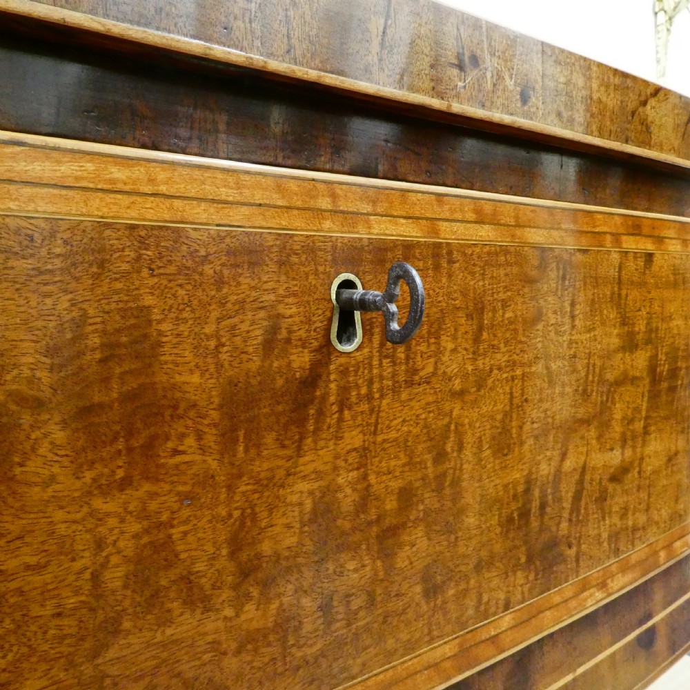 A Georgian mahogany bowfront side table featuring a single drawer with two oval brass handles and square tapered legs. View III