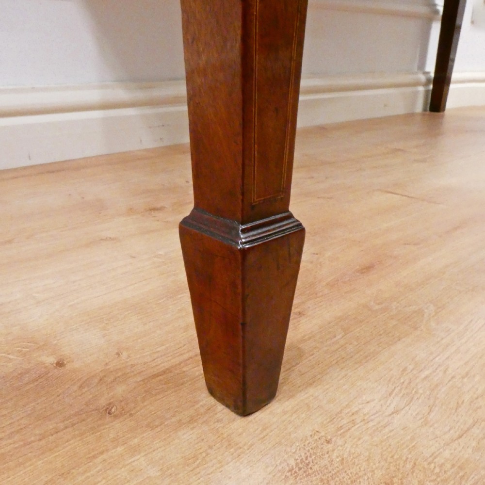A Georgian mahogany bowfront side table featuring a single drawer with two oval brass handles and square tapered legs. View XI
