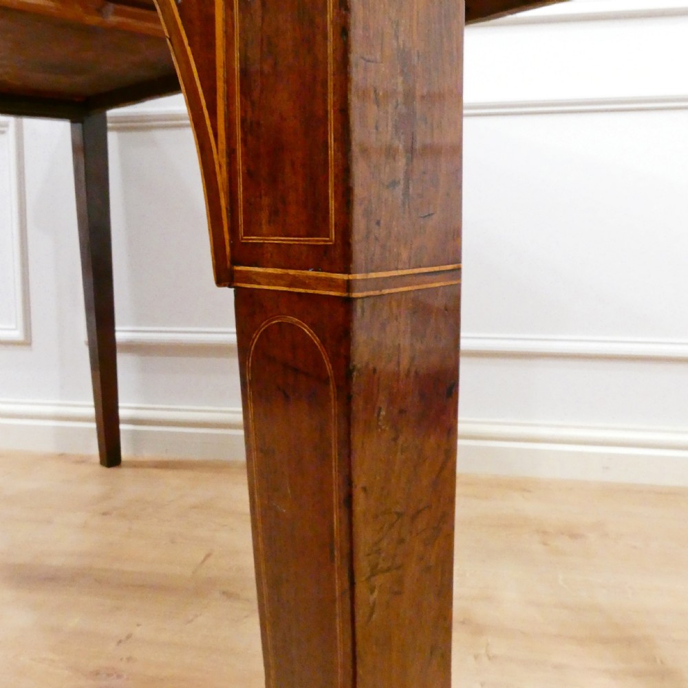 A Georgian mahogany bowfront side table featuring a single drawer with two oval brass handles and square tapered legs. View XIV