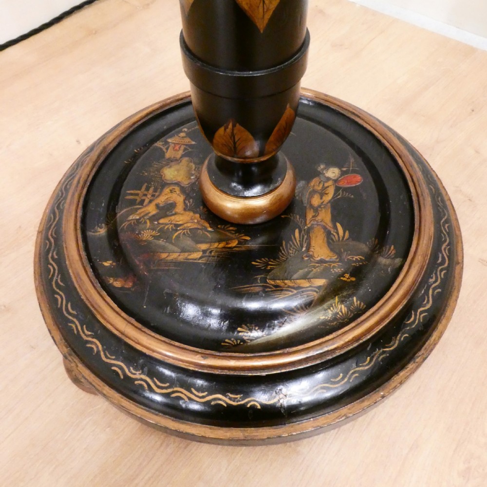 An Edwardian black lacquered standard lamp featuring hand-painted gold Chinoiserie motifs along a turned central shaft, resting on a moulded base with a fabric tassel shade. View II