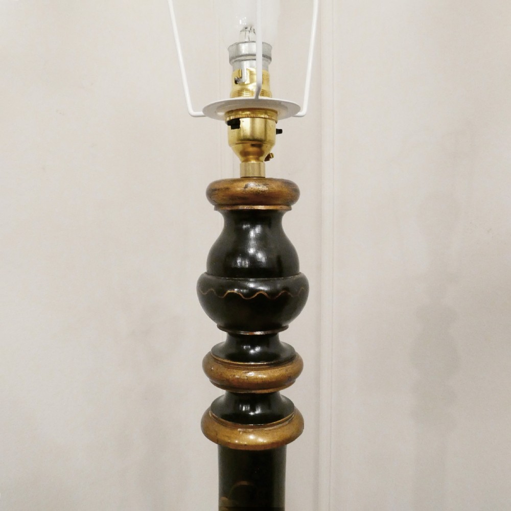 An Edwardian black lacquered standard lamp featuring hand-painted gold Chinoiserie motifs along a turned central shaft, resting on a moulded base with a fabric tassel shade. View VI