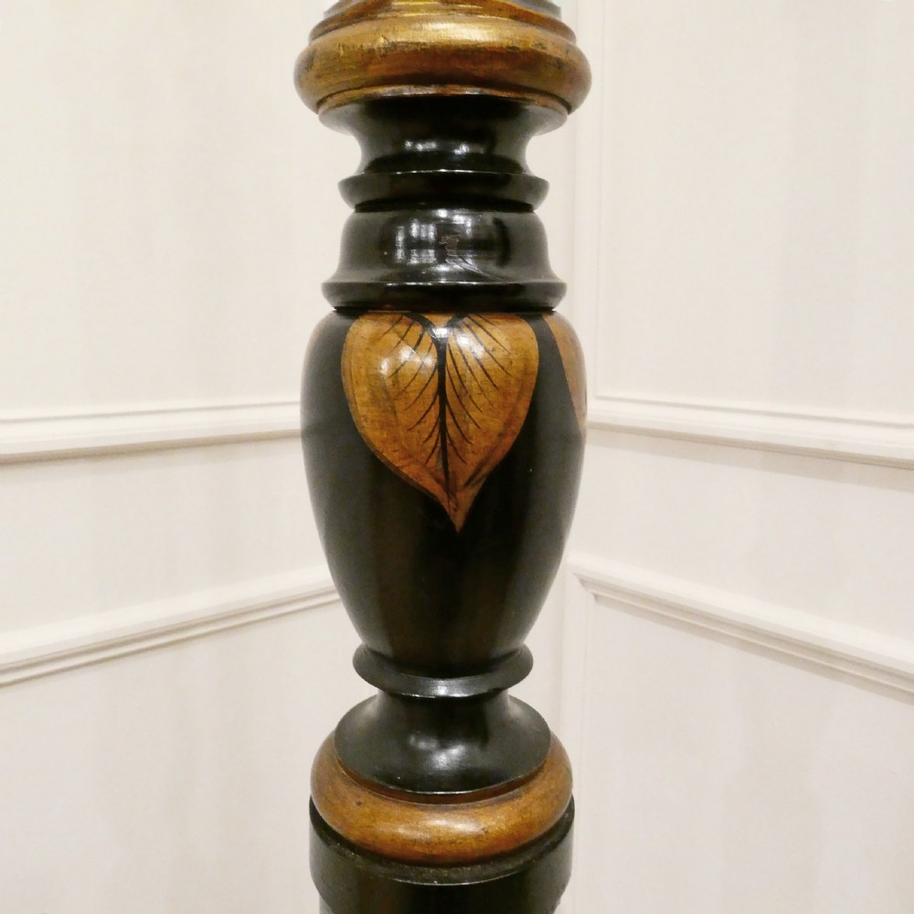An Edwardian black lacquered standard lamp featuring hand-painted gold Chinoiserie motifs along a turned central shaft, resting on a moulded base with a fabric tassel shade. View VII