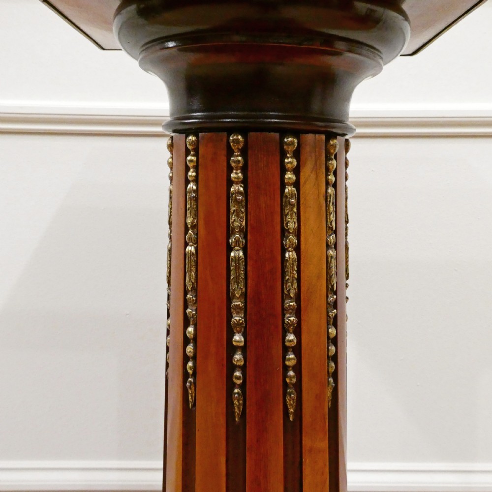 A pair of Victorian fluted satinwood column pedestals with square white marble tops and gilt mounts on plinth bases. View IV