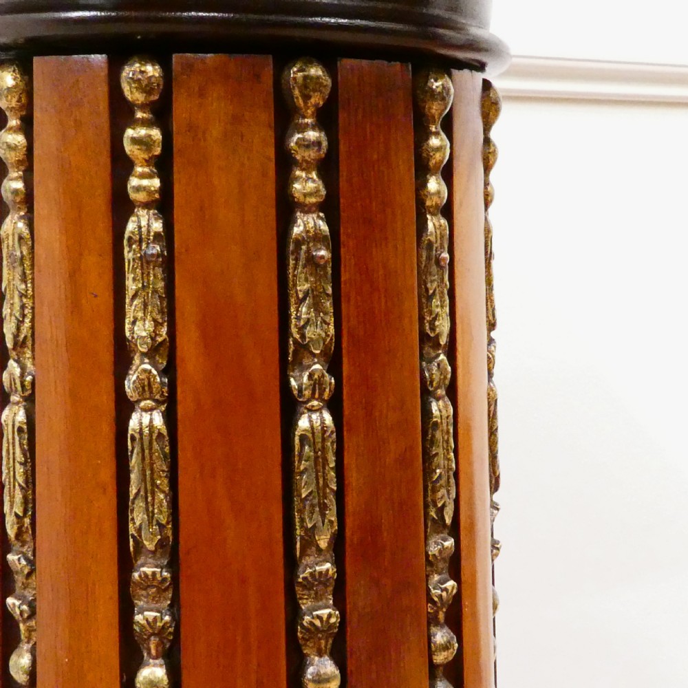 A pair of Victorian fluted satinwood column pedestals with square white marble tops and gilt mounts on plinth bases. View V