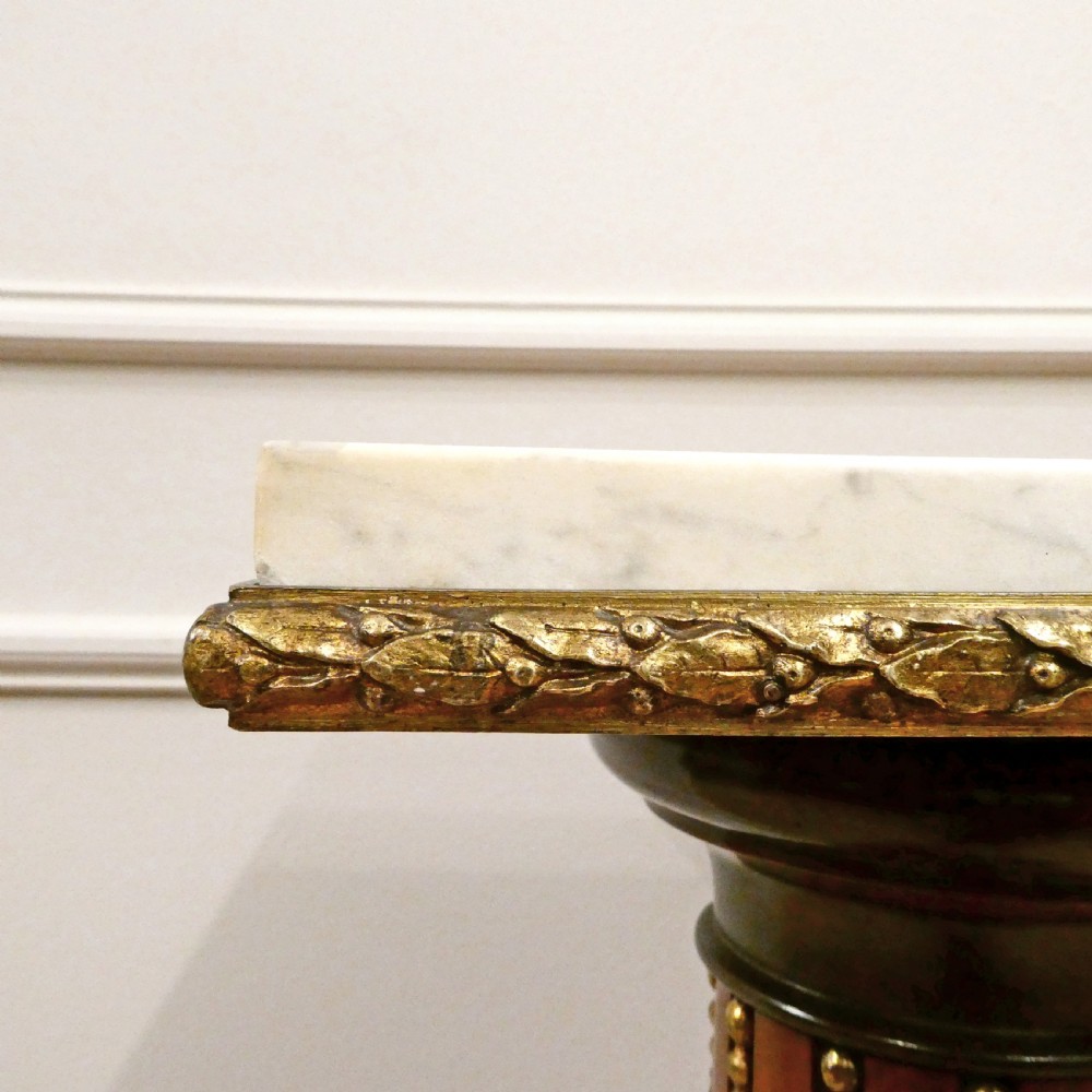 A pair of Victorian fluted satinwood column pedestals with square white marble tops and gilt mounts on plinth bases. View VI