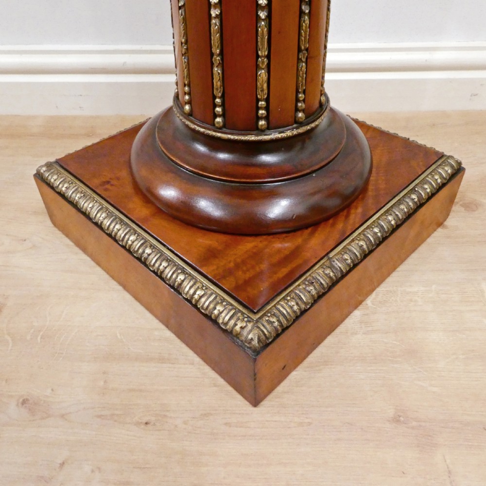 A pair of Victorian fluted satinwood column pedestals with square white marble tops and gilt mounts on plinth bases. View VIII