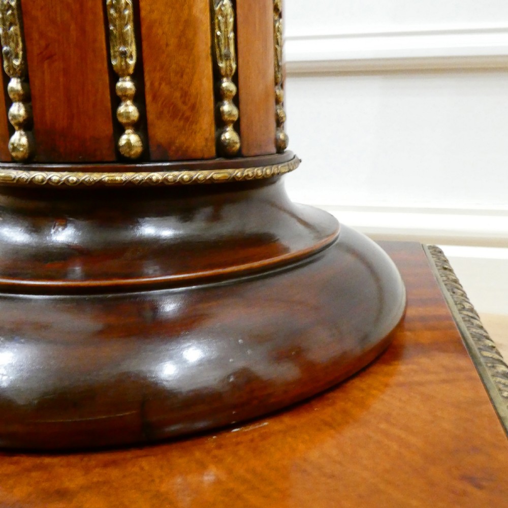 A pair of Victorian fluted satinwood column pedestals with square white marble tops and gilt mounts on plinth bases. View IX