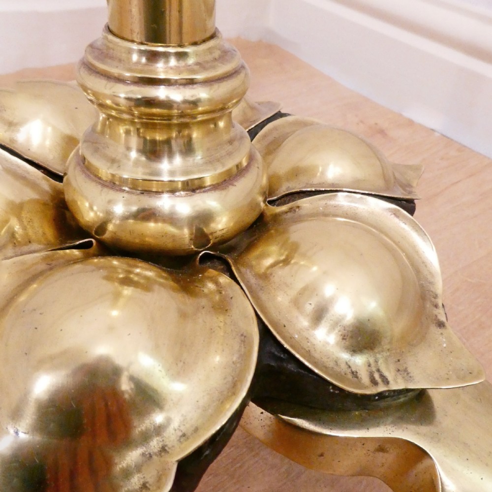 A tall brass standard lamp featuring a tripod base, slender central stem, and a gold fabric dome shade decorated with tassels and fringe. View IV