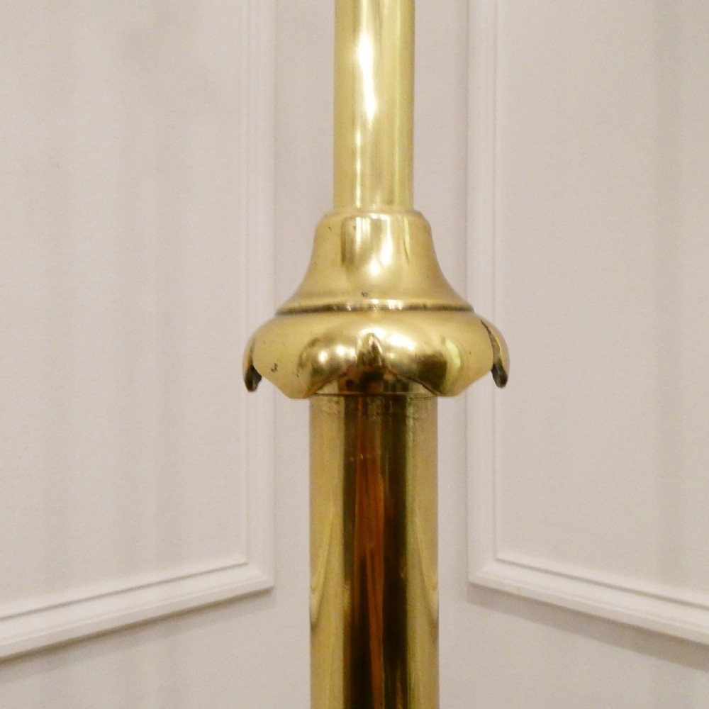 A tall brass standard lamp featuring a tripod base, slender central stem, and a gold fabric dome shade decorated with tassels and fringe. View VII