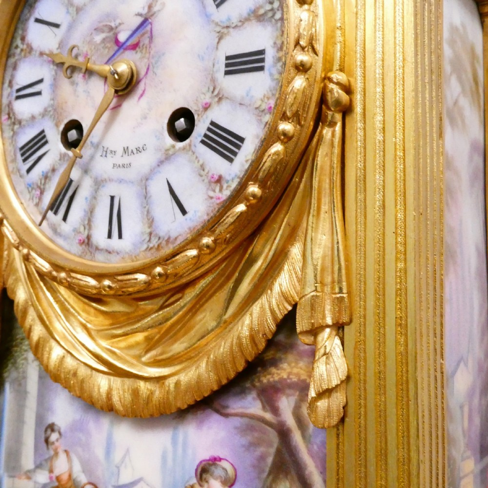 A French Louis XVI style gilt bronze mantel clock featuring a porcelain urn top, hand-painted floral porcelain panels, and Roman numerals on the dial. View V