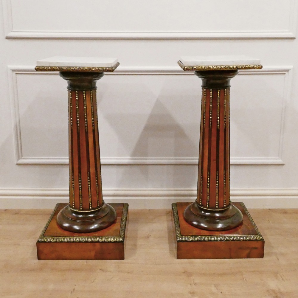 A pair of Victorian fluted satinwood column pedestals with square white marble tops and gilt mounts on plinth bases. View XIII