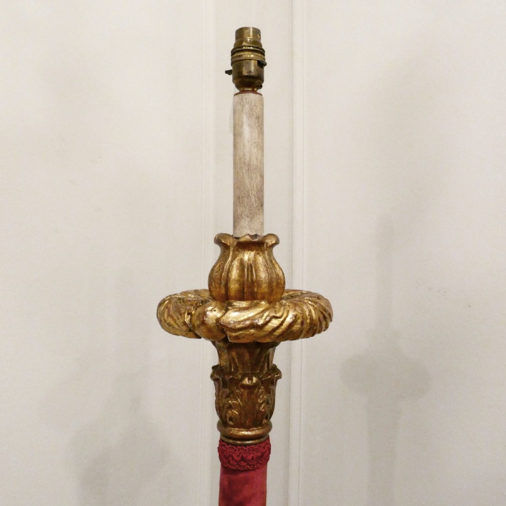 A pair of tall Italian Baroque style giltwood floor lamps featuring red velvet shafts and scalloped fringed shades. View III