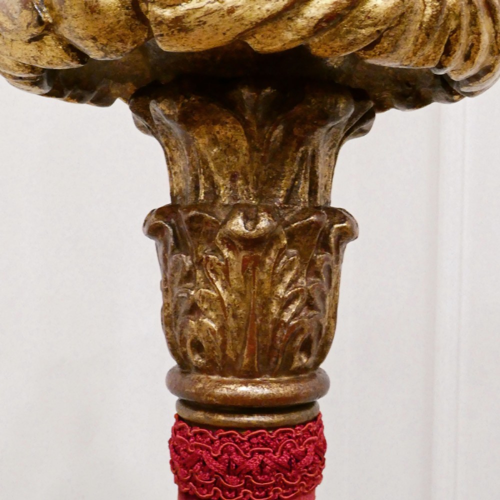 A pair of tall Italian Baroque style giltwood floor lamps featuring red velvet shafts and scalloped fringed shades. View IV