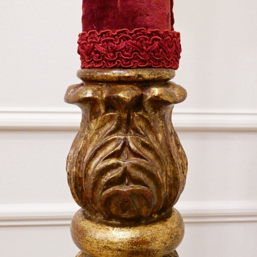 A pair of tall Italian Baroque style giltwood floor lamps featuring red velvet shafts and scalloped fringed shades. View X