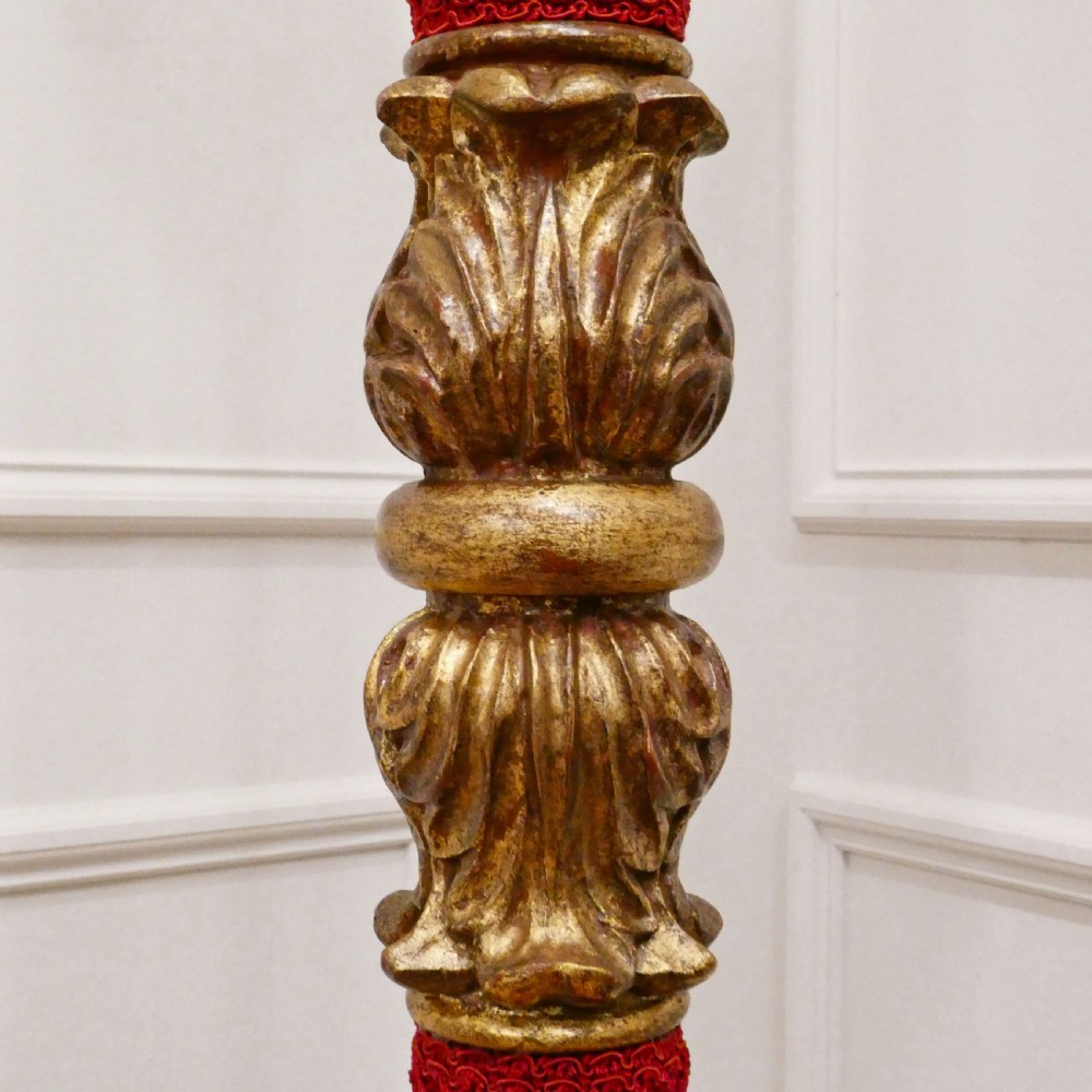A pair of tall Italian Baroque style giltwood floor lamps featuring red velvet shafts and scalloped fringed shades. View XI