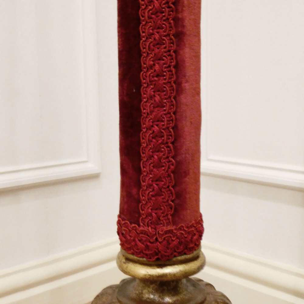 A pair of tall Italian Baroque style giltwood floor lamps featuring red velvet shafts and scalloped fringed shades. View XII