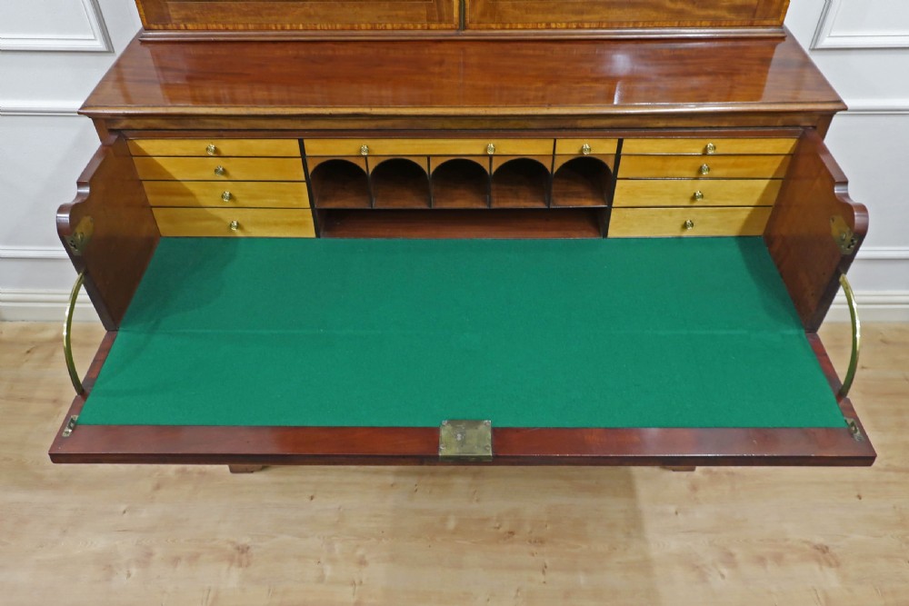 A Georgian mahogany secretaire bookcase featuring upper glazed doors with astragal bars above a pull-out writing drawer and lower panel doors with marquetry inlays. View XVI