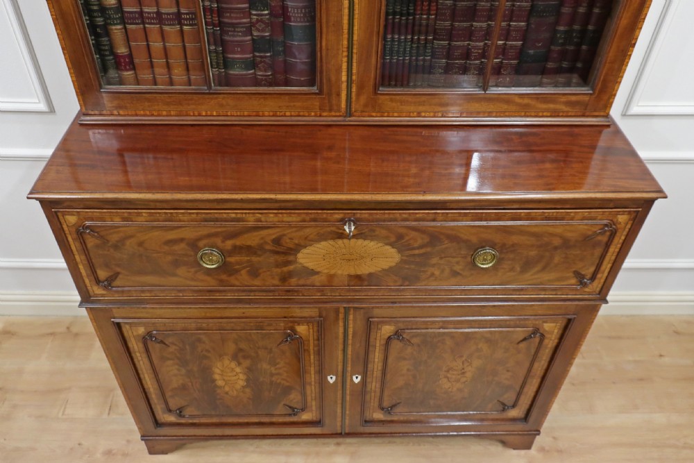 A Georgian mahogany secretaire bookcase featuring upper glazed doors with astragal bars above a pull-out writing drawer and lower panel doors with marquetry inlays. View XXIII