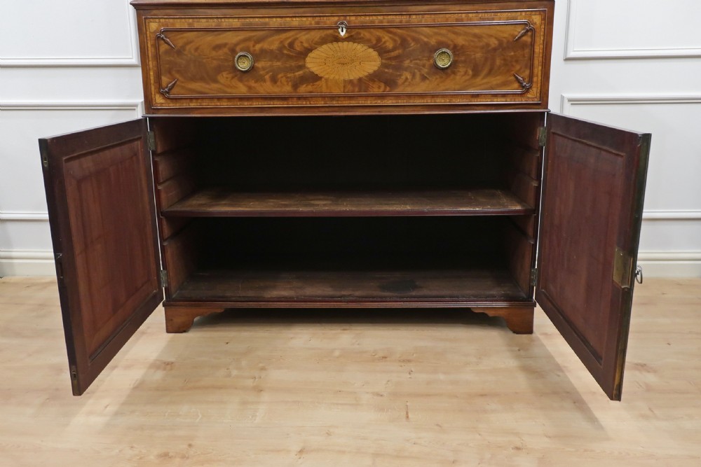 A Georgian mahogany secretaire bookcase featuring upper glazed doors with astragal bars above a pull-out writing drawer and lower panel doors with marquetry inlays. View XXIV