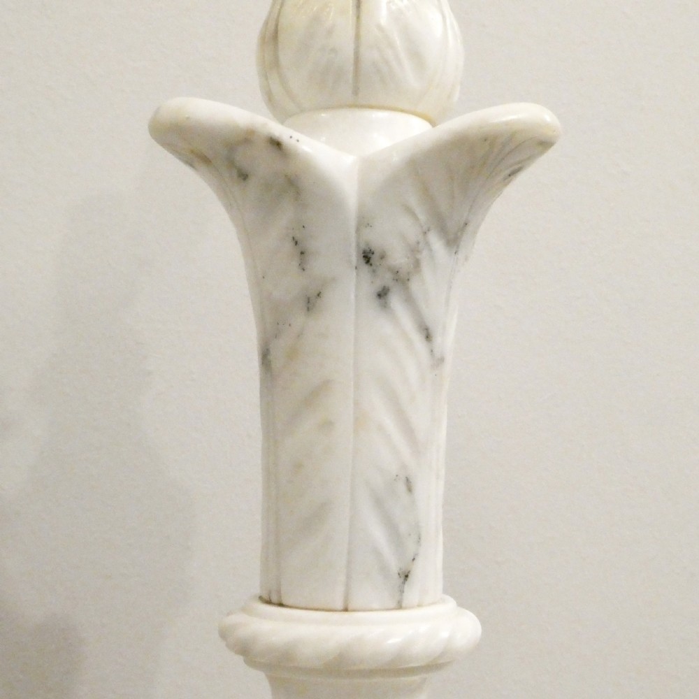 An early 20th-century carved white alabaster table lamp featuring an urn-shaped stem, square plinth base, and a pleated white fabric lampshade. View IV