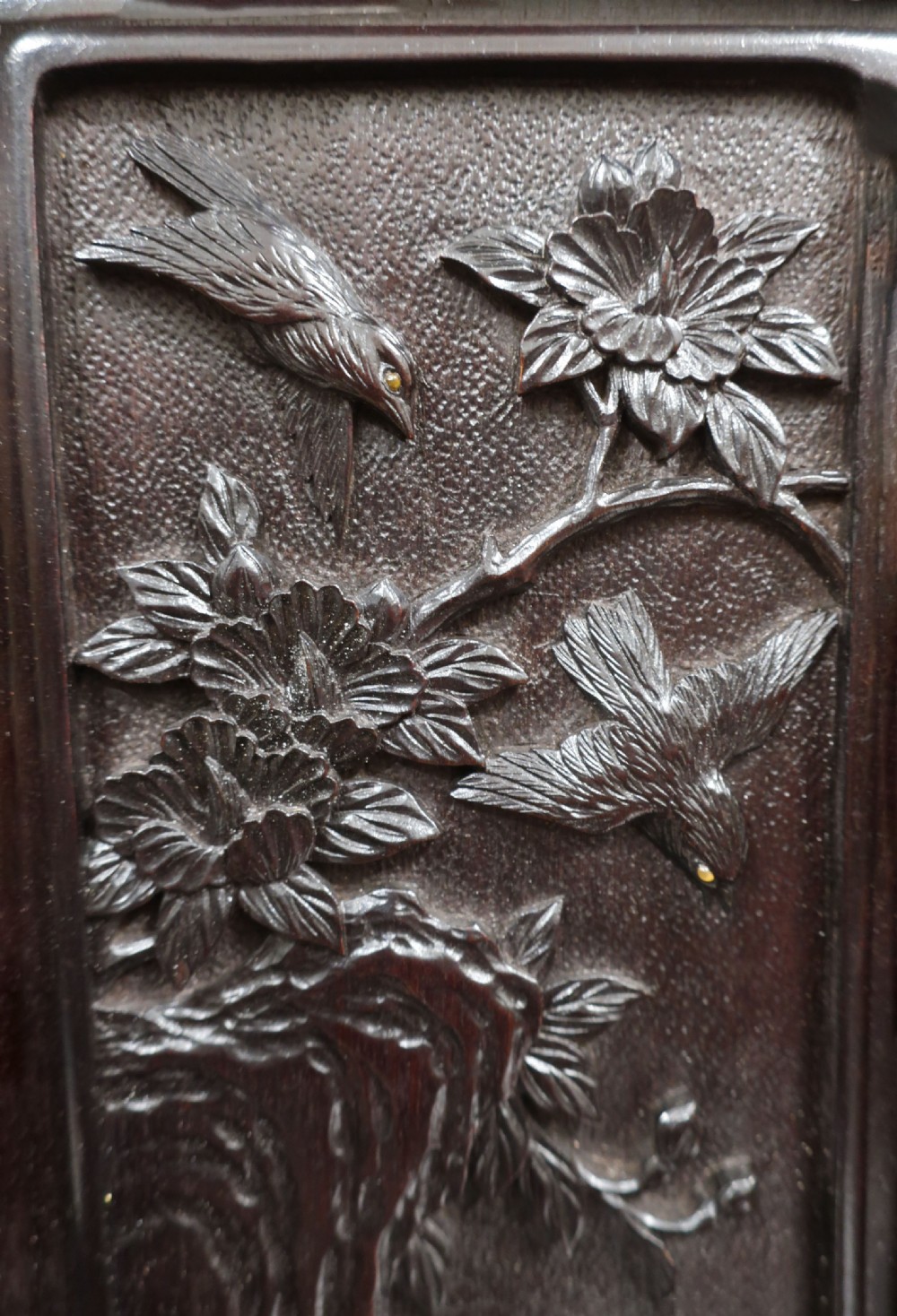 A dark carved hardwood Japanese Meiji period shodana cabinet featuring asymmetrical shelves, relief-carved panel doors, metal mounts, and a carved lower base. View XII