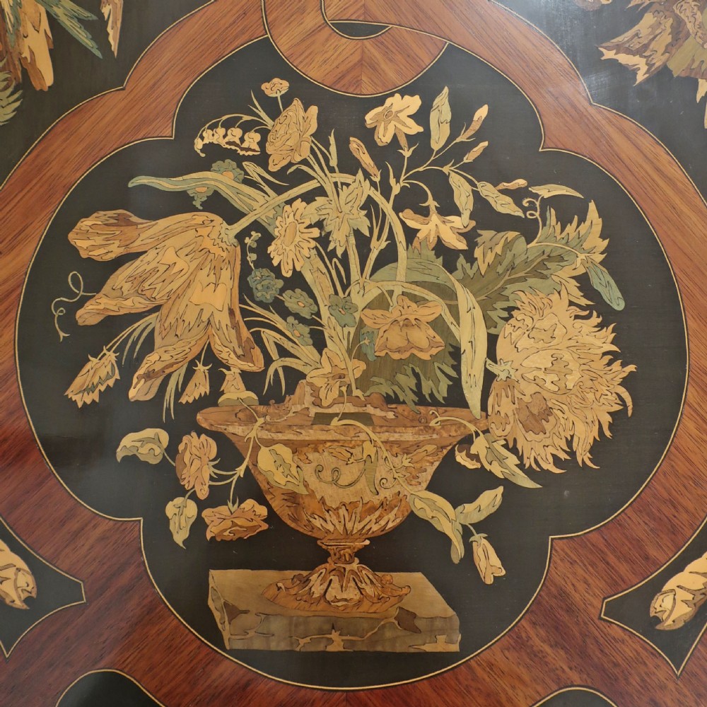 A French Louis XV style writing table featuring a serpentine top with floral marquetry inlay, cabriole legs, and gilt-bronze mounts. View VI