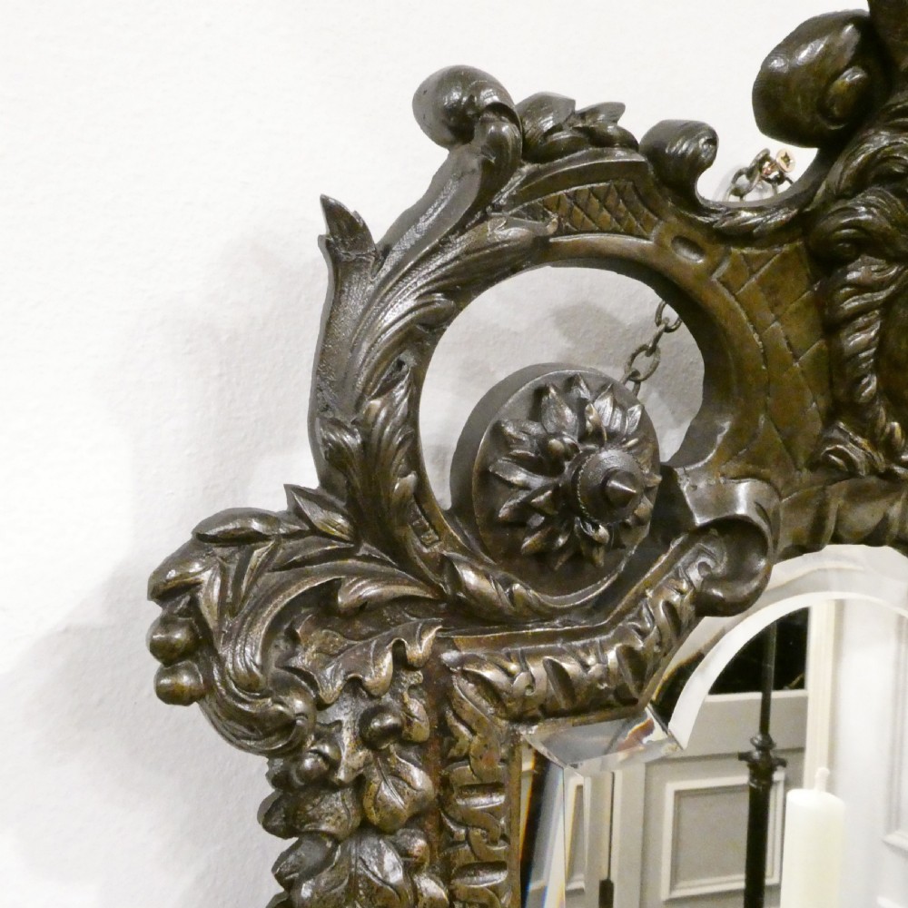A pair of dark patinated bronze wall girandoles with ornate foliate frames surrounding central mirrored plates and three candle branches each. View XI