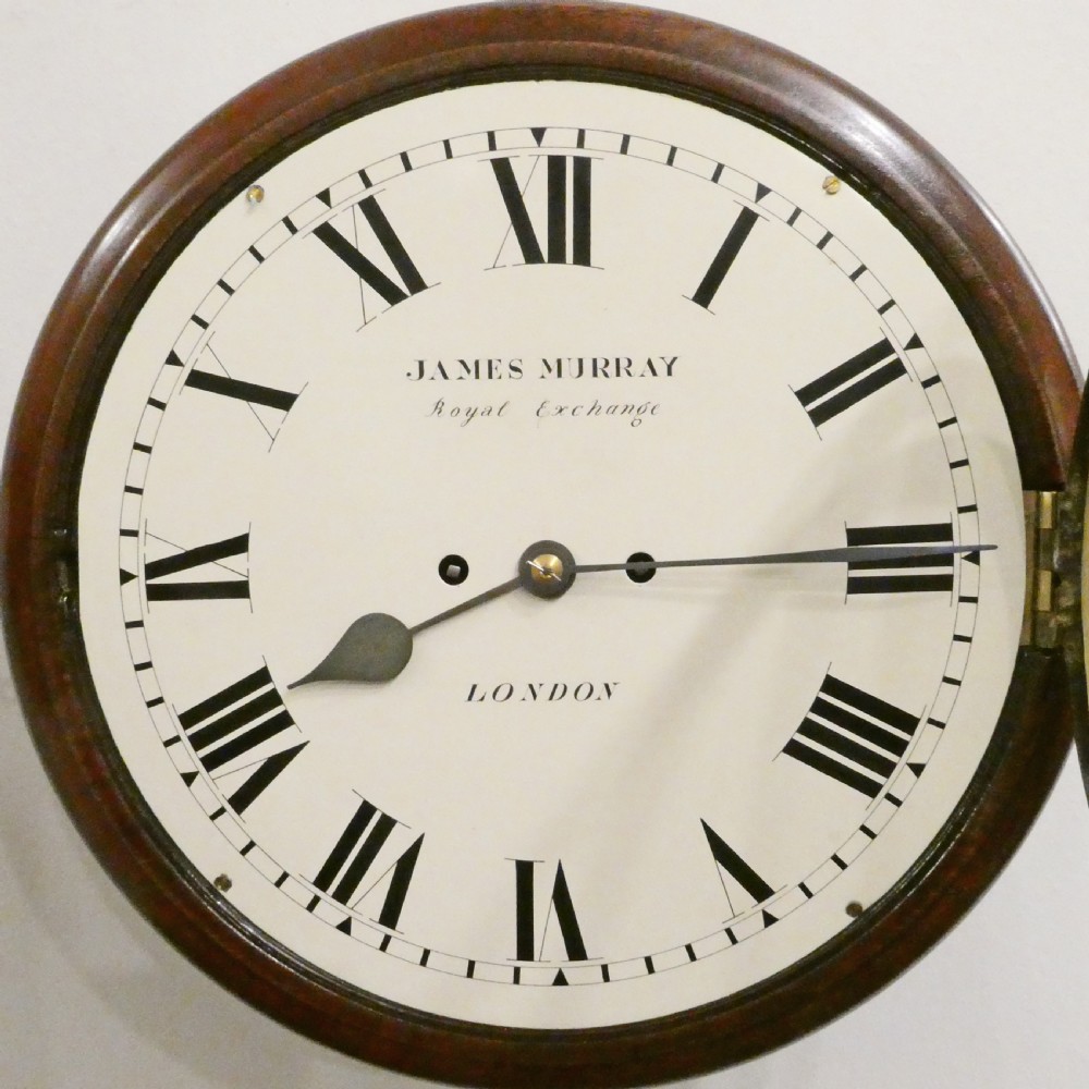 A circular Georgian wall clock featuring a mahogany surround, brass bezel, white dial with Roman numerals, and signature reading James Murray London. View III