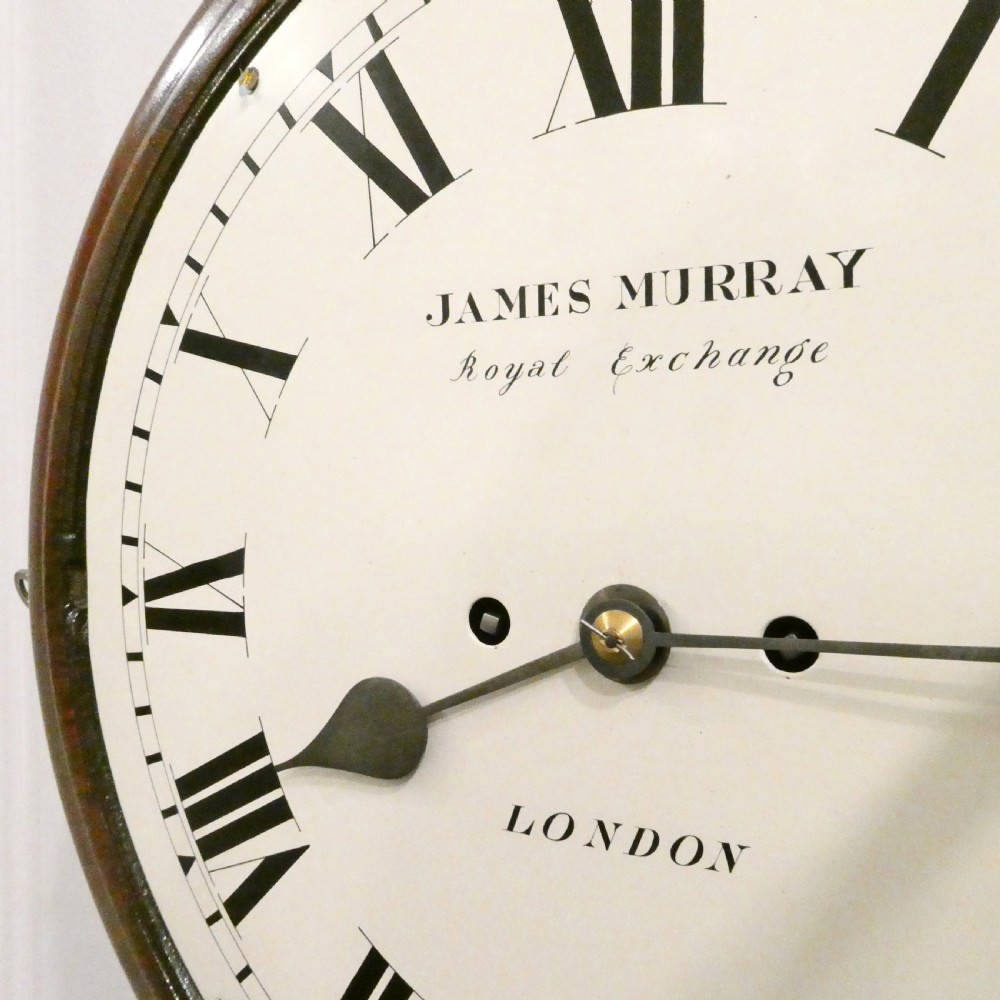 A circular Georgian wall clock featuring a mahogany surround, brass bezel, white dial with Roman numerals, and signature reading James Murray London. View IV