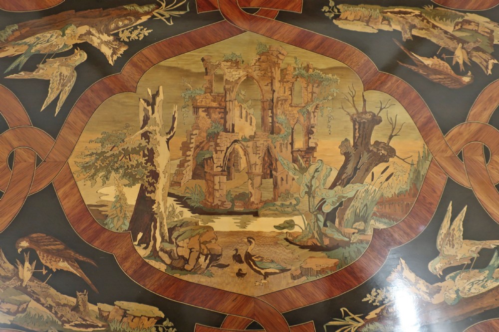 A French Louis XV style bureau plat writing table decorated with intricate floral marquetry inlay, sweeping cabriole legs, and ornate gilt-bronze mounts. View III