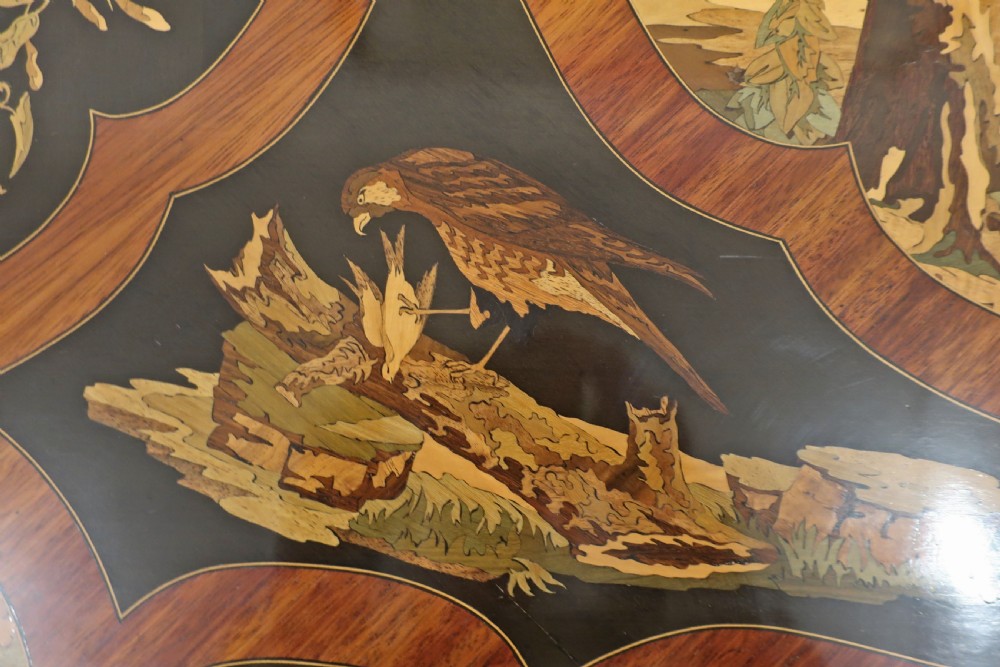 A French Louis XV style bureau plat writing table decorated with intricate floral marquetry inlay, sweeping cabriole legs, and ornate gilt-bronze mounts. View IV