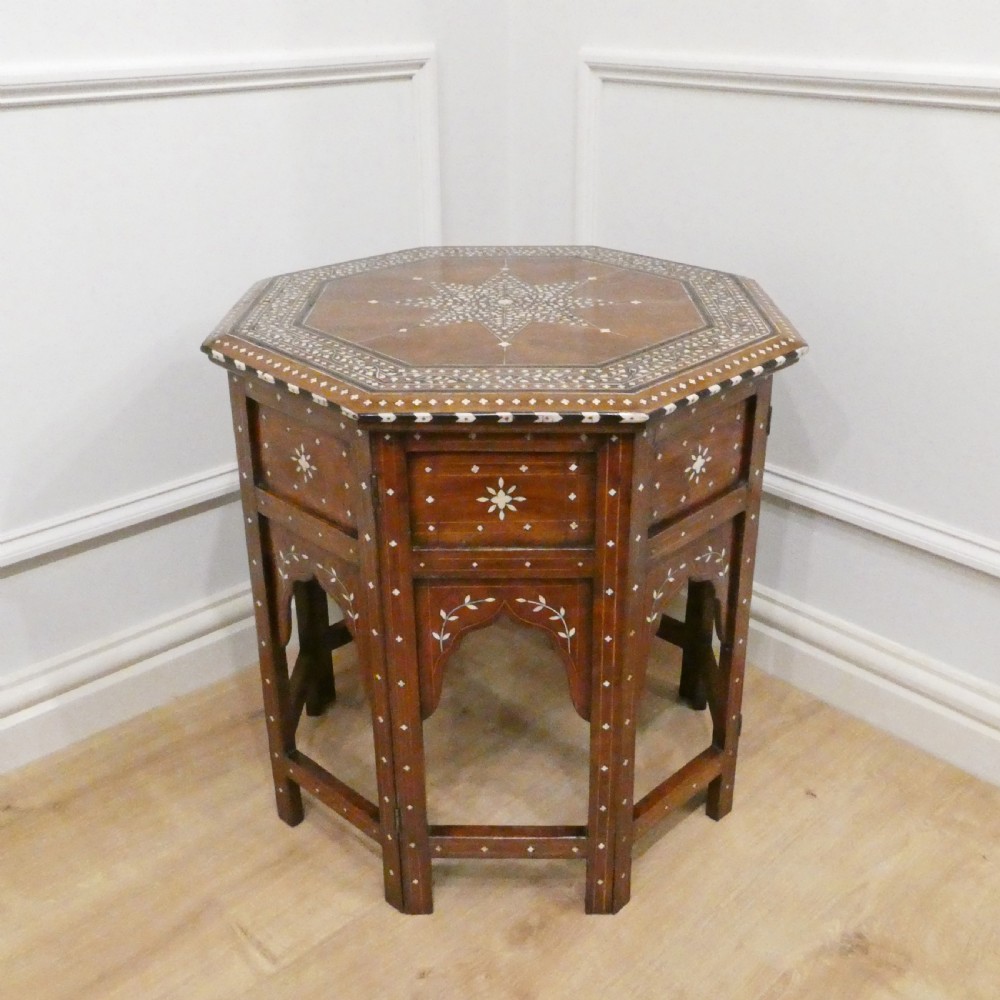 Late 19th-century octagonal wooden side table featuring intricate geometric bone inlay and an architectural arched base.