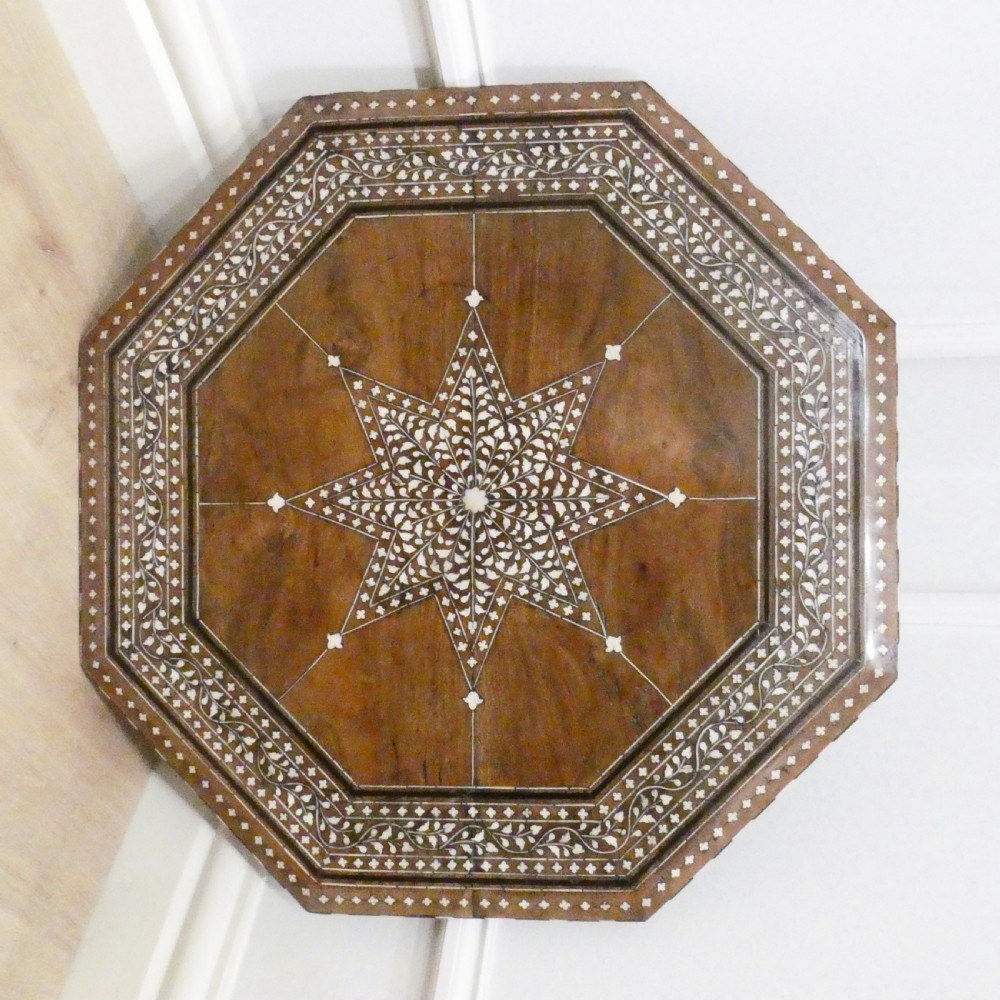 Late 19th-century octagonal wooden side table featuring intricate geometric bone inlay and an architectural arched base. View II