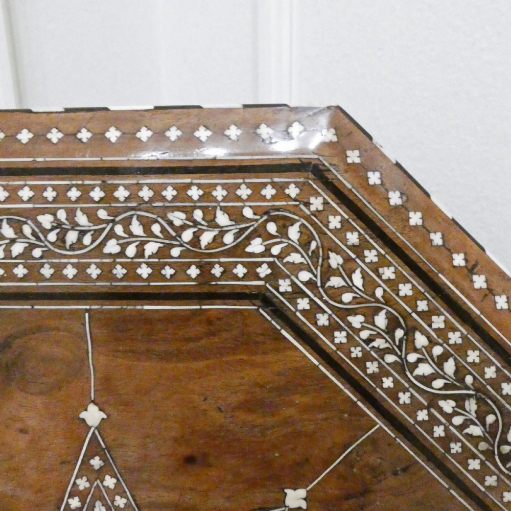 Late 19th-century octagonal wooden side table featuring intricate geometric bone inlay and an architectural arched base. View V
