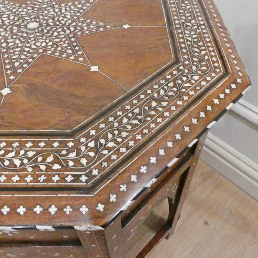 Late 19th-century octagonal wooden side table featuring intricate geometric bone inlay and an architectural arched base. View VII