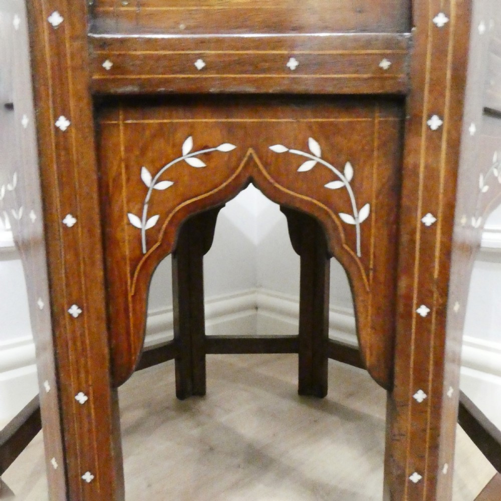 Late 19th-century octagonal wooden side table featuring intricate geometric bone inlay and an architectural arched base. View X