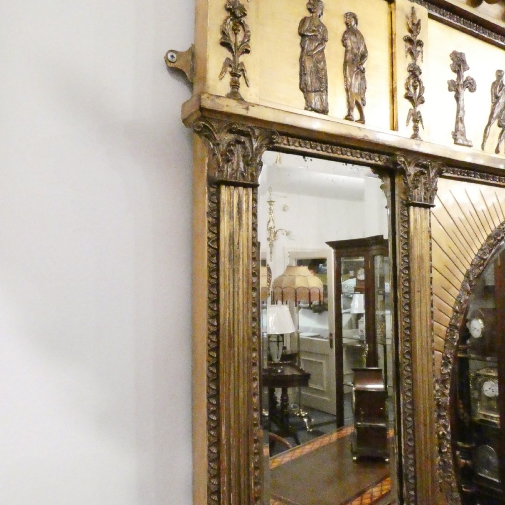 A rectangular giltwood overmantel wall mirror featuring a classical relief frieze above a central circular mirror plate flanked by two rectangular mirrored sections. View VIII
