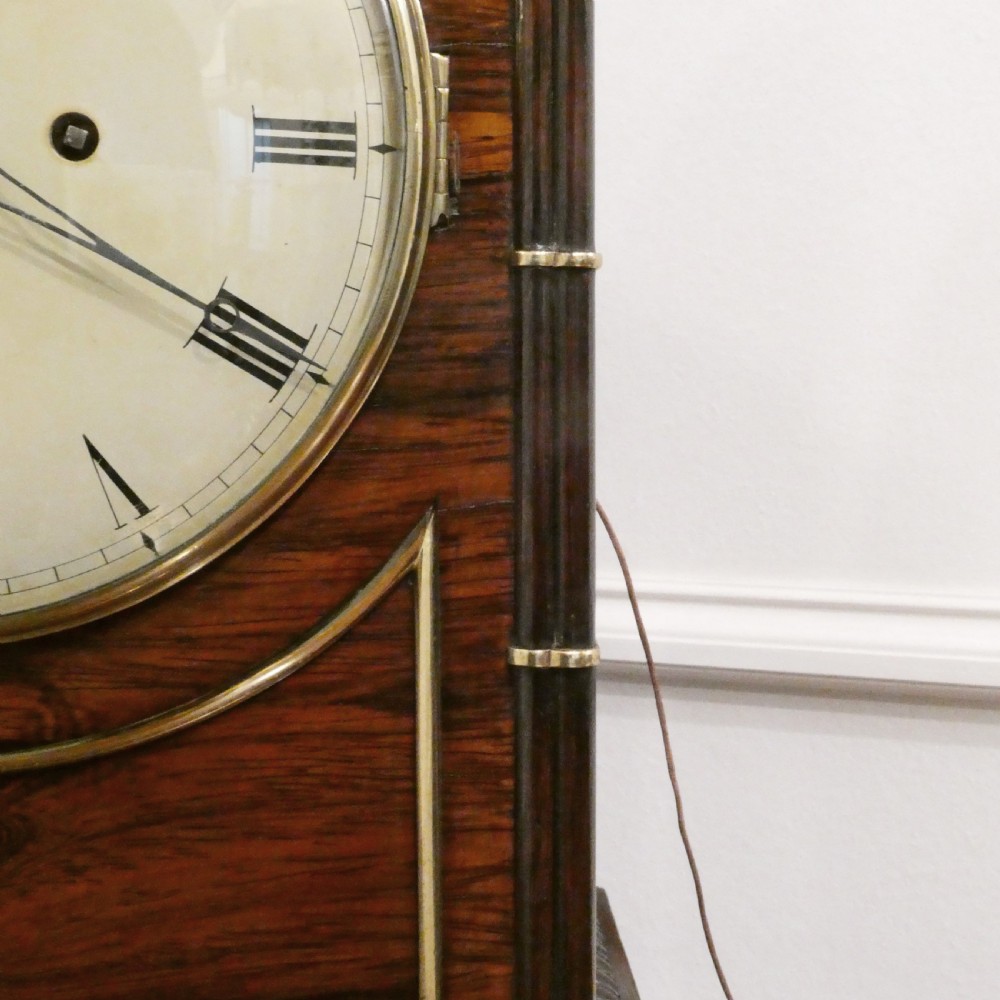 A dark rosewood William IV bracket clock featuring a gothic arch top, brass finials, brass feet, and a white dial signed Barber and North of York. View VI