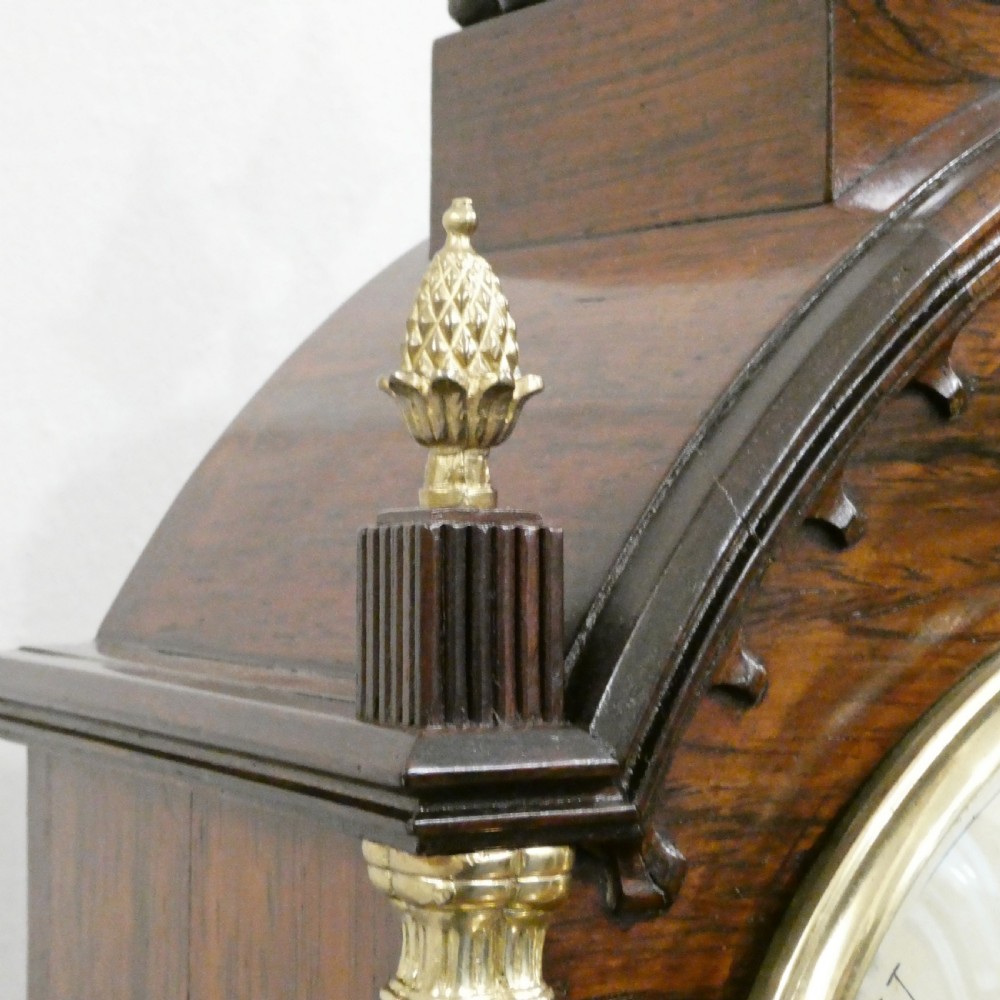 A dark rosewood William IV bracket clock featuring a gothic arch top, brass finials, brass feet, and a white dial signed Barber and North of York. View VIII