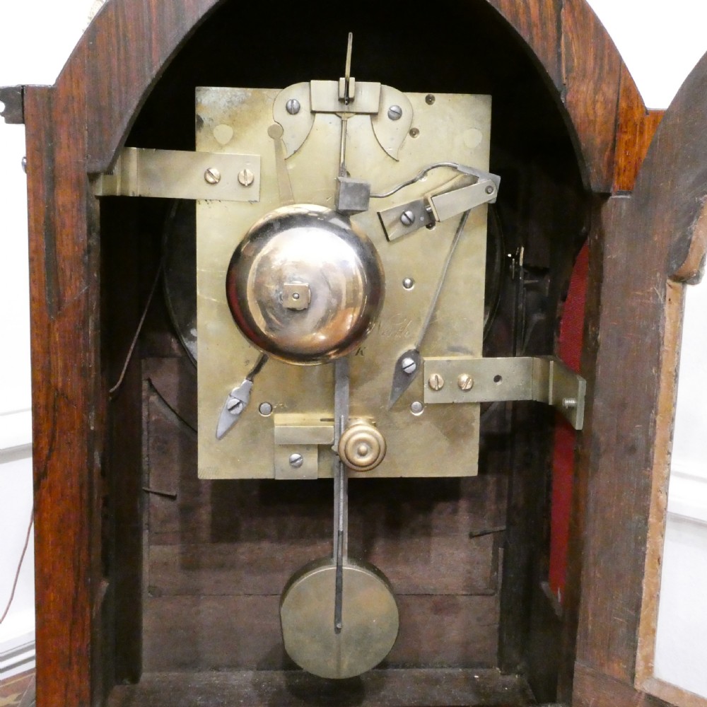 A dark rosewood William IV bracket clock featuring a gothic arch top, brass finials, brass feet, and a white dial signed Barber and North of York. View XV
