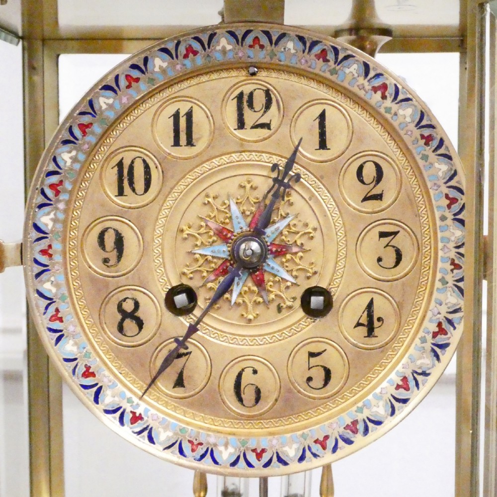 A late nineteenth-century French four-glass mantel clock featuring a green onyx base and top, champleve enamel borders, and a visible mercury pendulum. View III